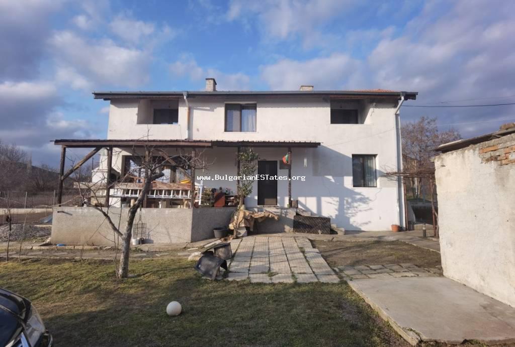 Massive two-storey house with a large yard for sale in the village of Kamenar, just 6 km from the city of Pomorie and the sea. Real estate in Bulgaria for sale.